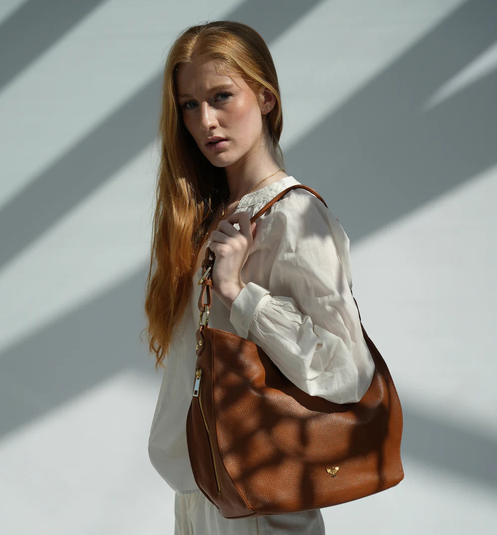 The Harriet tan leather hobo bag featuring a timeless, slouchy design with elegant detailing and everyday functionality-1