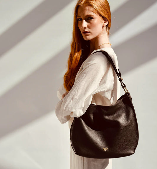 The Harriet tan leather hobo bag featuring a timeless, slouchy design with elegant detailing and everyday functionality
