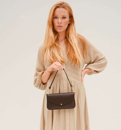 The Munro black leather shoulder bag featuring a sleek, sophisticated design with versatile compartments for everyday use